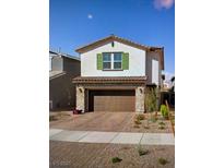 Charming two-story home featuring stone accents and a well-maintained desert landscaped front yard at 392 Canary Song Dr, Henderson, NV 89011