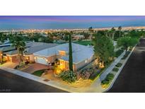 Breathtaking aerial view of the home, golf course, and Las Vegas city lights in the background at 4286 Pacifico Ln, Las Vegas, NV 89135