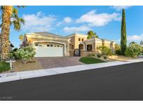 Stunning single-story home featuring well-manicured landscaping, a spacious garage, and a brick driveway at 4286 Pacifico Ln, Las Vegas, NV 89135