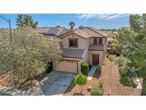 Charming two-story home with a tile roof and a well-manicured front yard in a suburban neighborhood at 4562 Sparwood Dr, Las Vegas, NV 89147
