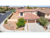 Beautiful two-story home showcasing a well-manicured front yard and a spacious three-car garage at 512 Los Dolces St, Las Vegas, NV 89138