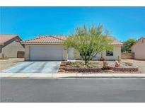 Charming single-story home featuring a well-manicured front yard and a two-car garage at 5236 Krista Alethea St, North Las Vegas, NV 89031