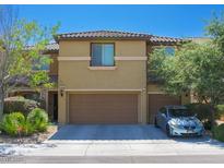 Charming two-story townhouse with well-maintained landscaping and a two-car garage at 5507 Gemini Bridges St, Las Vegas, NV 89130