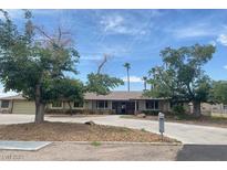 Ranch-style home featuring desert landscaping, a circular driveway, and mature shade trees in the front yard at 6315 Eldora Ave, Las Vegas, NV 89146
