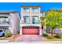 Charming three-story home with stucco and stone accents, bright red garage door, and a cozy second story balcony at 7032 Steele Canyon St, Las Vegas, NV 89118