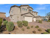 Charming stucco two-story home with a brick driveway and well-maintained landscaping at 7051 Denio Island St, North Las Vegas, NV 89084