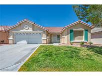 Charming single-story home featuring desert landscaping, a spacious lawn, and a two car garage at 7824 Faith Ct, Las Vegas, NV 89131
