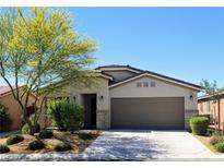 Charming single-story home with a well-maintained lawn and a two-car garage, set against a clear blue sky at 8305 Minots Ledge Ave, Las Vegas, NV 89147