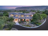 Expansive home with desert landscaping, mountain views, and solar panels for energy efficiency at 11 Misty Peaks Ct, Las Vegas, NV 89135