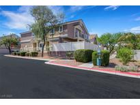 Attractive multi-story townhome with desert landscaping, white fence, and a well-maintained exterior at 1101 Elation Ln # 2, Henderson, NV 89002