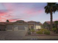 Charming single-story home featuring desert landscaping, a two-car garage, and a classic tile roof at 1128 Galangate Ave, Henderson, NV 89015