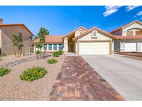 Charming single-story home with a two-car garage, tile roof, and desert landscaping at 234 Geronimo Ct, Henderson, NV 89074
