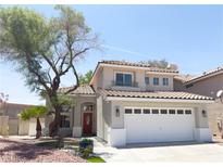 Charming two-story home with a well-maintained yard, red door and a two car garage at 2429 Worchester Rd, Henderson, NV 89074