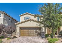 Charming two-story home featuring a brick driveway, a spacious two-car garage, and inviting landscaping at 2806 Calle Cadiz, Henderson, NV 89044