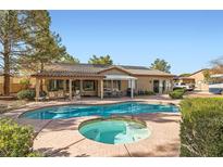 A beautiful backyard pool and spa are the centerpieces of this outdoor living space at 313 Glenridding St, Las Vegas, NV 89183
