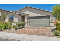 Charming single-story home featuring a two-car garage, desert landscaping, and neutral color palette at 3716 W Colton Ave, North Las Vegas, NV 89032