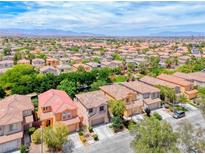 Expansive aerial view of a residential community with neat landscaping and mountain views at 4044 Villeroy Ave, Las Vegas, NV 89141