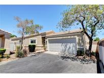 Charming single-story home with a two-car garage, desert landscaping, and a well-maintained front yard at 5043 Mascaro Dr, Las Vegas, NV 89122