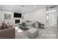 Bright living room featuring a fireplace, a sofa, an armchair, and a coffee table with modern decorations at 5191 Caliente St # 84, Las Vegas, NV 89119