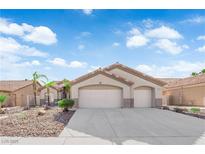 Charming single-story home featuring a two-car garage, desert landscaping, and a tile roof at 5437 Escallonia St, Las Vegas, NV 89149