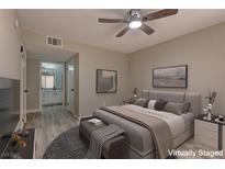 Comfortable bedroom featuring a ceiling fan, neutral walls, and ensuite bathroom with a spacious countertop at 5710 E Tropicana Ave # 1216, Las Vegas, NV 89122