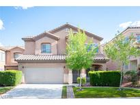 Charming two-story home with a well-manicured front yard and a two-car garage under a sunny sky at 6029 Allanche Ave, Las Vegas, NV 89141