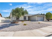 Charming single-story home featuring desert landscaping, a gray roof, and an attached two-car garage at 6204 Robin Hood Cir, Las Vegas, NV 89108