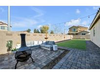 Inviting backyard featuring a cozy lounge area and a well-maintained lawn, perfect for relaxation and entertaining at 6318 Amber Sunrise St, North Las Vegas, NV 89031
