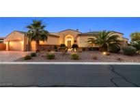 Charming single-story home featuring desert landscaping, a paver driveway, and a 3 car garage at 7504 Frittata Ave, Las Vegas, NV 89113