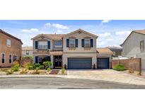 Charming two-story home with a well-maintained lawn, mature plants, and a two-car garage at 831 E Galingale Ct, Henderson, NV 89015