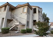 Exterior of a condominium featuring stucco, stairs, and tile roofing at 855 N Stephanie St # 2311, Henderson, NV 89014