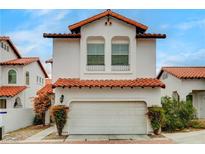 Charming two-story home featuring a Spanish-style roof and an attached two-car garage at 8789 Villa Alex Ave, Las Vegas, NV 89147