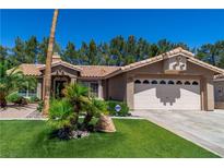 Charming single-story home with well-manicured lawn and mature landscaping with desert accents at 906 Sitting Bull Dr, Henderson, NV 89014