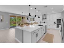 Spacious modern kitchen with a large center island, white cabinetry, and stainless steel appliances at 9643 Wildflower Vista Ave, Las Vegas, NV 89166