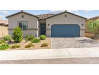 Charming single-story home with a well-maintained yard and a blue garage door at 10951 Stone Crossing Ave, Las Vegas, NV 89166