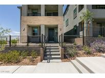 Contemporary three-story home with a stone facade and front yard landscaping at 11552 Ashy Storm Ave, Las Vegas, NV 89138