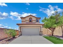 Charming two-story home with a tan exterior, tile roof, and an attached two-car garage at 11787 Fern Creek Ln, Las Vegas, NV 89183