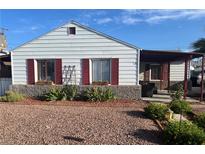 Charming single-story home featuring a well-maintained front yard with red shutters and stone accents at 123 Cedar St, Henderson, NV 89015