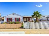 Charming single-story home featuring a white picket fence and well-maintained landscaping at 123 Cedar St, Henderson, NV 89015