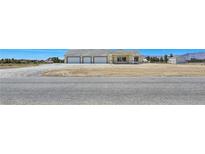 Spacious single-story home featuring a large three-car garage and neutral color scheme at 1351 Huckleberry St, Pahrump, NV 89048