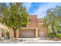 Contemporary two-story home with a two-car garage and desert landscaping at 1448 Canyon Ledge Ct, Las Vegas, NV 89117