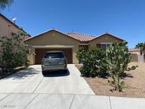 Charming single-story home with a low-maintenance landscape and long driveway to a two car garage at 152 Lotus Vale Ave, Las Vegas, NV 89123