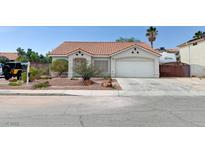 Charming single-story home featuring desert landscaping, a two-car garage, and a classic tile roof at 1523 Silver Point Ave, Las Vegas, NV 89123