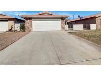 Charming single-story home featuring a two-car garage and stone accents at 1832 Yellow Rose St, Las Vegas, NV 89108