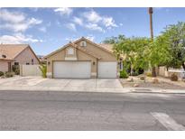 Charming single-story home featuring a two-car garage and well-maintained desert landscaping at 1845 Candle Bright Dr, Henderson, NV 89074