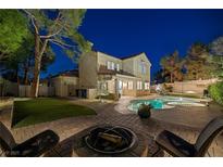 Beautiful backyard features a pool, fire pit, and outdoor seating area perfect for entertaining at 1921 Spyglass Dr, Henderson, NV 89074