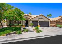 Charming single-story home featuring a well-manicured lawn and a three-car garage at 211 Kokopelli Ct, Henderson, NV 89074