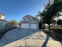Charming two-story home featuring a three-car garage and well-maintained front yard at 2306 Jared Ct, North Las Vegas, NV 89032