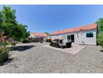 Spacious backyard features gravel landscaping, tiled patio, and outdoor seating area, perfect for entertaining at 3823 Aspen Creek Ave, North Las Vegas, NV 89031