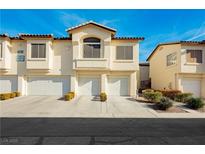 Charming townhome featuring attached garages, beautiful architecture, and well-maintained landscaping at 4810 Grey Wolf Ln # 104, Las Vegas, NV 89149